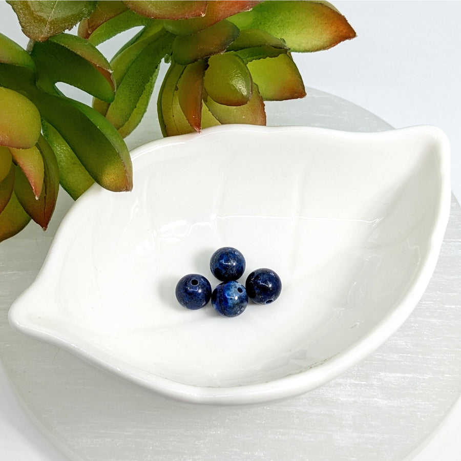 White ceramic leaf-shaped dish with Lapis Dark Blue 8mm round beads