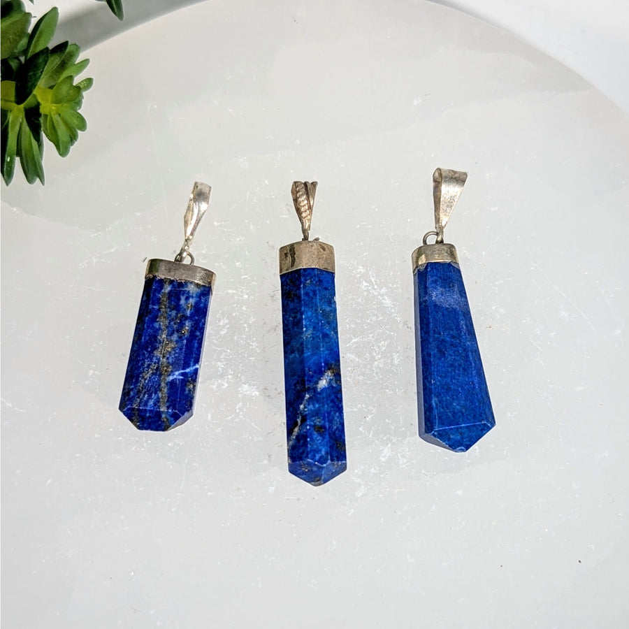 Three polished blue lapis lazuli point pendants with silver caps, 1.5-2 inches