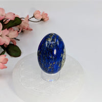 Thumbnail for Polished Lapis Lazuli 2’’ Egg with golden pyrite inclusions on a clear stand