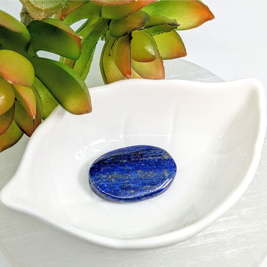 Polished Lapis Lazuli 32mm flat oval bead showcasing deep blue color and gold streaks