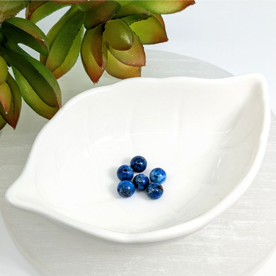 White leaf-shaped dish with Lapis Light Blue 6.5mm Round Beads in six-pack