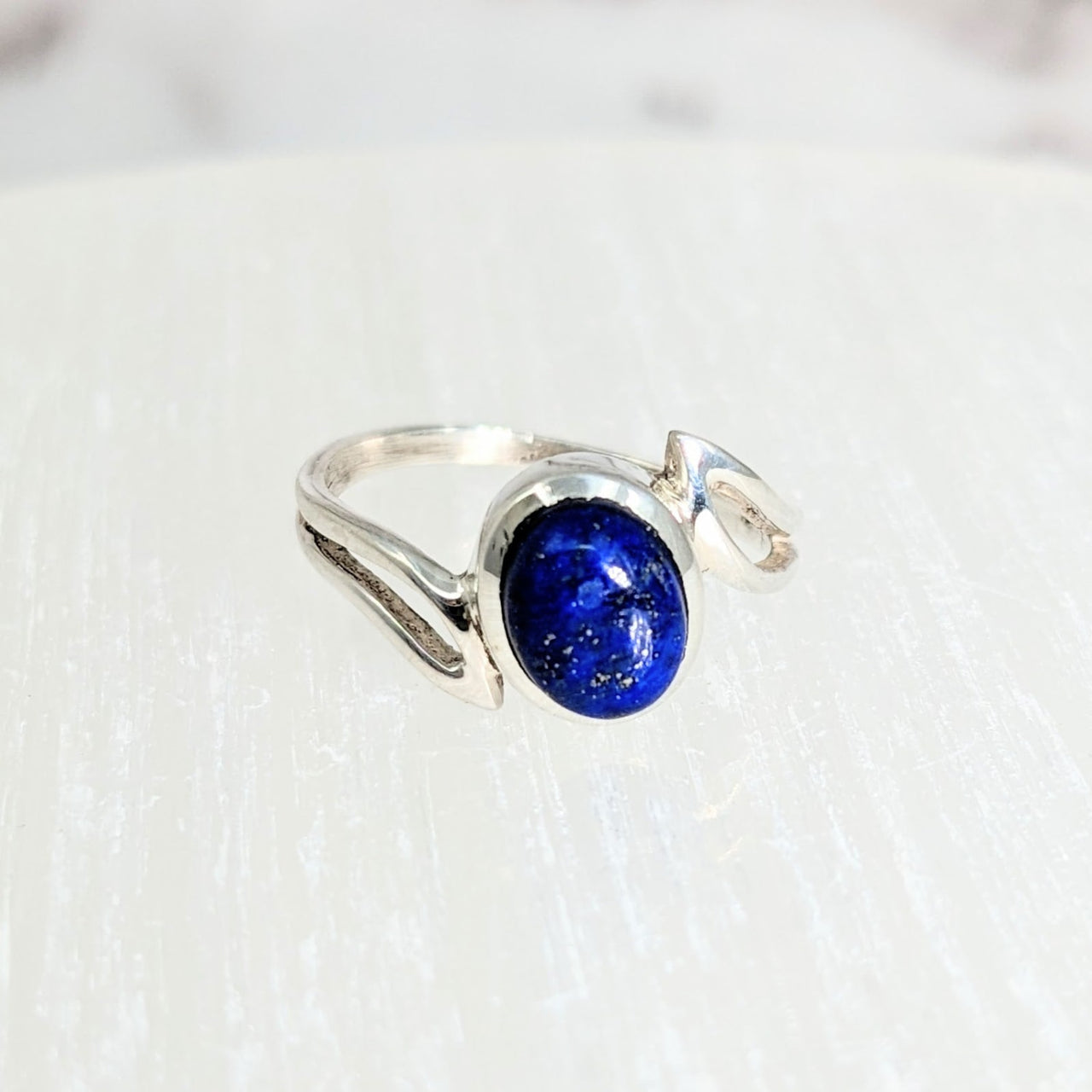 Lapis S.S. Swoop Ring with Blue Stone on Table - Available in Various Sizes #LV2117