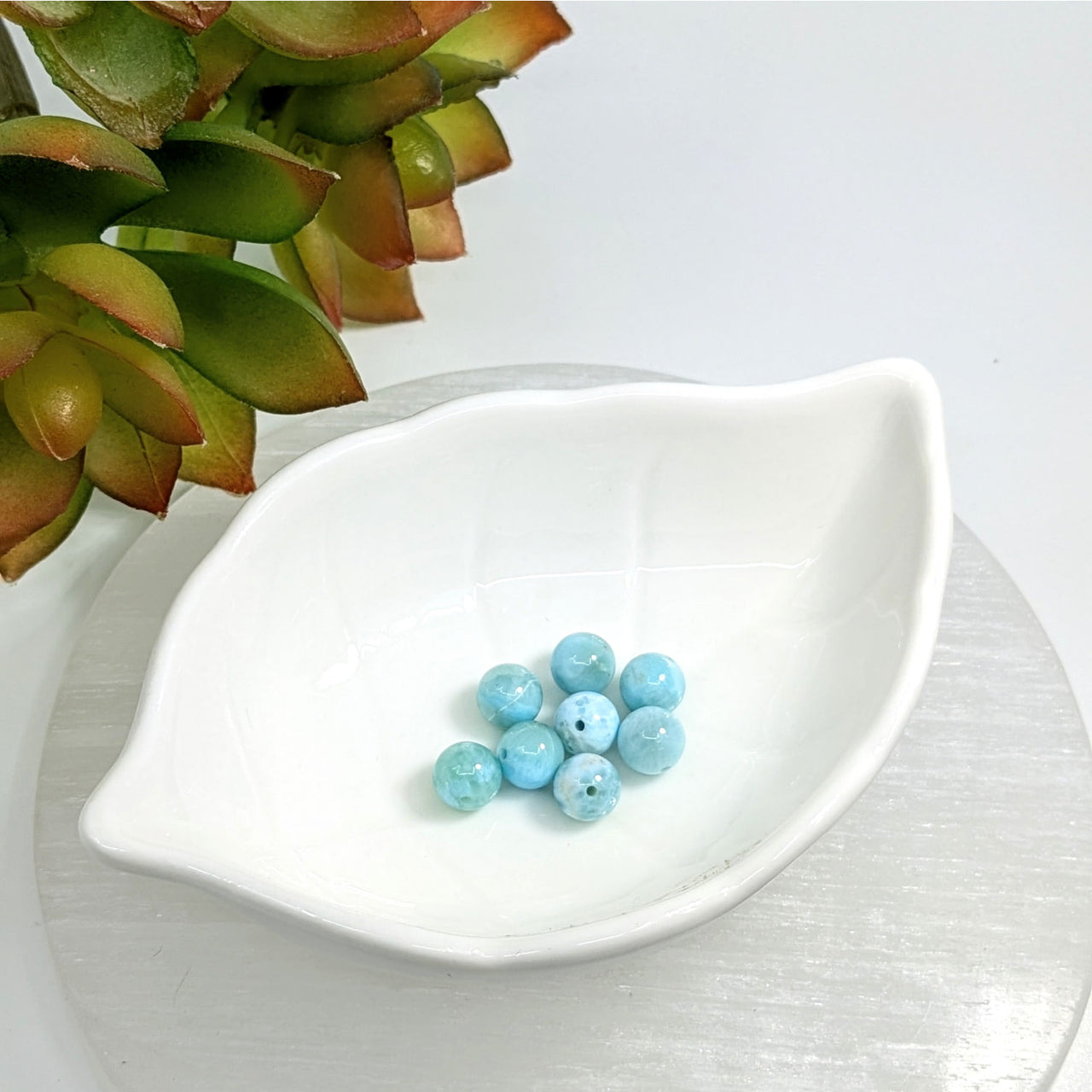 White ceramic dish with turquoise beads featuring Larimar 7mm round bead design