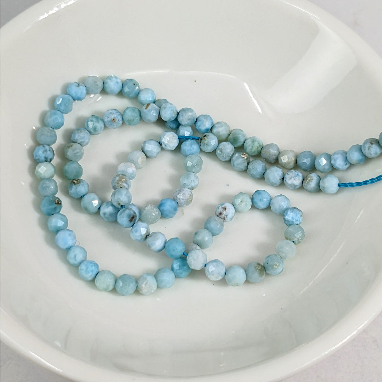 Larimar Faceted 3 mm Bead 12 Pack #LV3614: Blue Necklace on White Plate