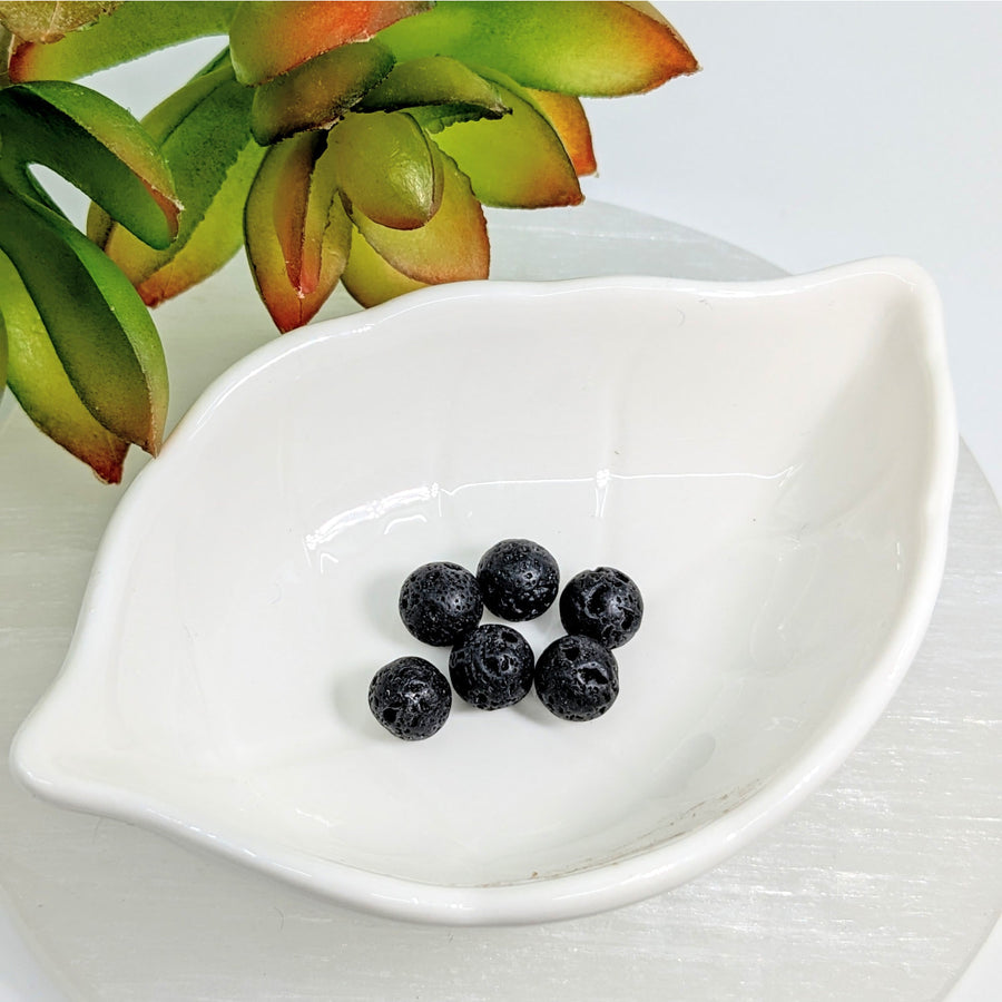 Fresh blueberries in a white dish beside Lava Beads 8mm Large Round pack of 6