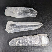 Thumbnail for Three quartz crystals on black surface - Lazer Seed Quartz 2.8’ Rough Point #LV3433