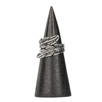 Leaf adjustable ring in silver feather design on dark wooden cone