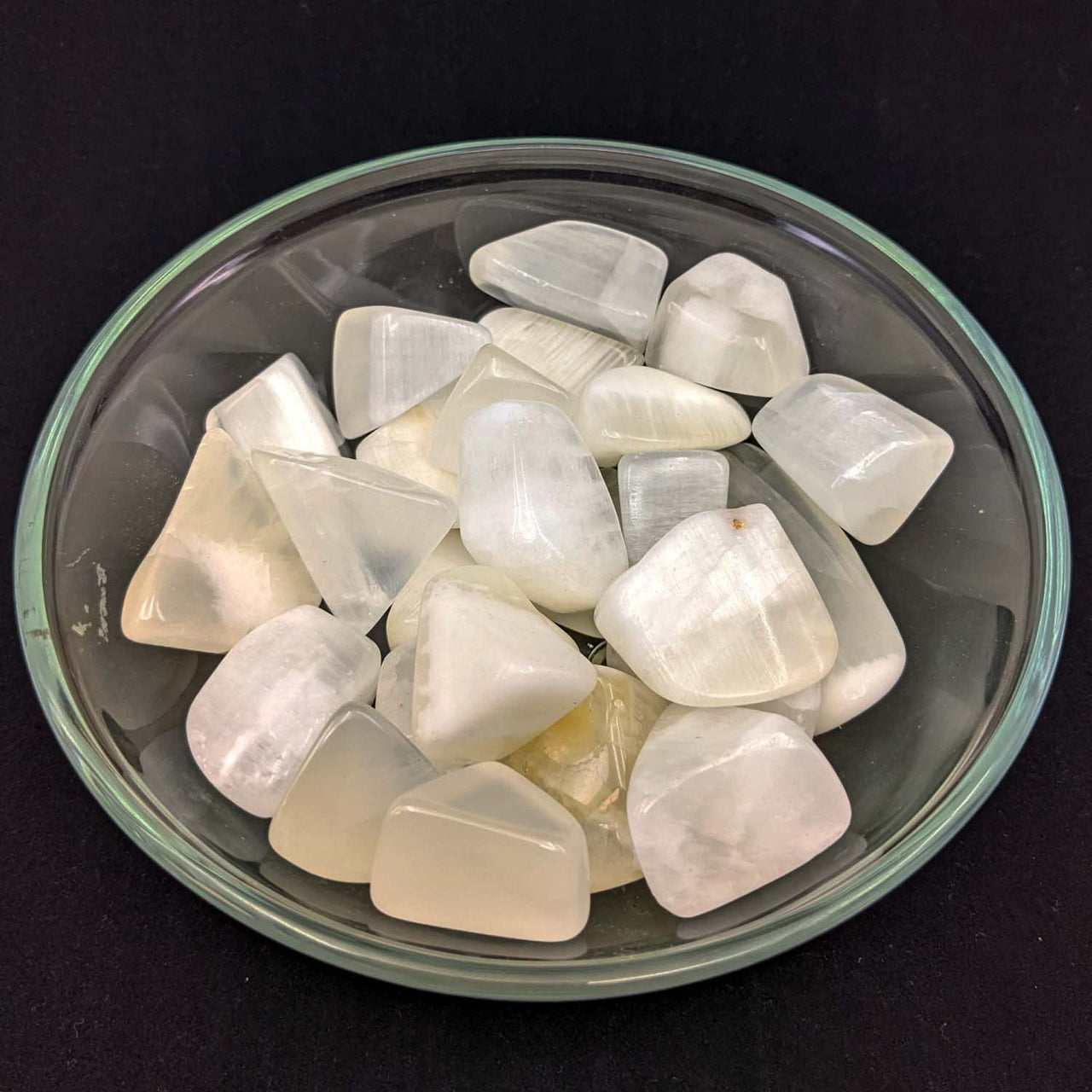 Bowl of tumbled Moonstones with Lemon Calcite Tumbled Stones in a product display
