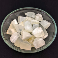 Bowl of tumbled Moonstones with Lemon Calcite Tumbled Stones in a product display