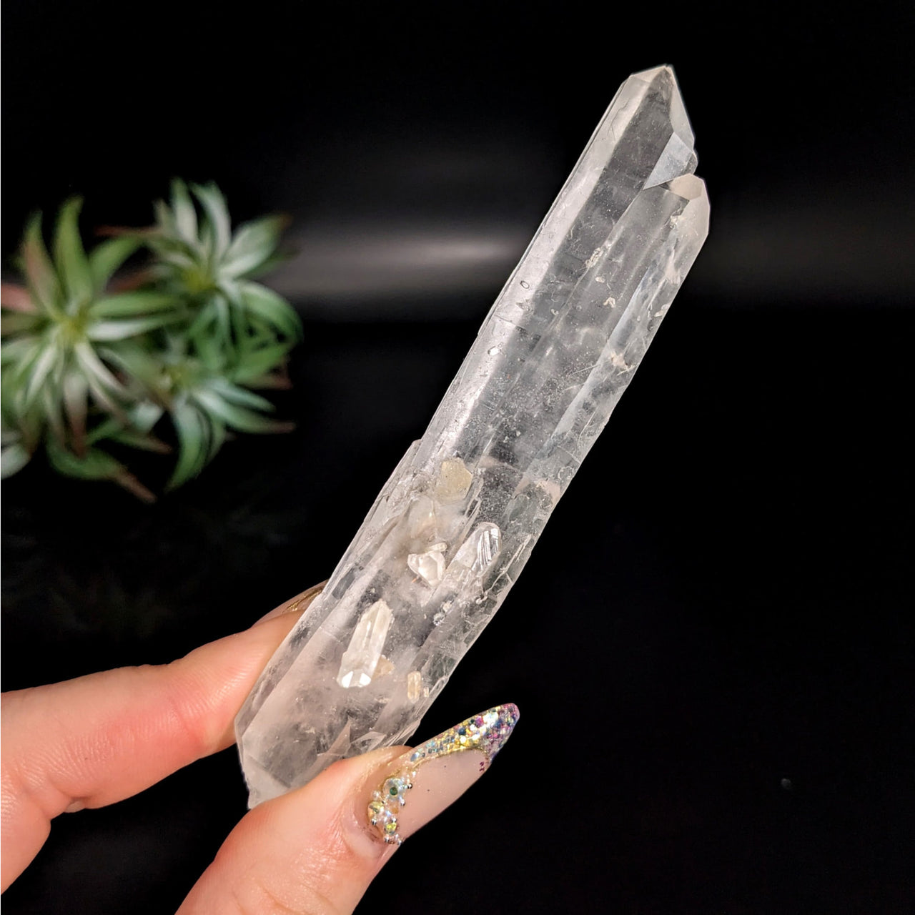 Person holding Lemurian Quartz 4.4’ Rough Point #LV4769 with a clear, sparkling crystal stone