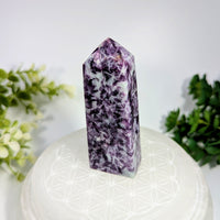Lepidolite 3.2 inch obelisk tower made of polished purple and white fluorite crystal with a pointed top on an ornamental base