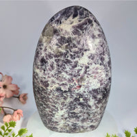 A polished lepidolite 6.5 inch egg-shaped amethyst geode with deep purple and white quartz veins for crystals and jewelry