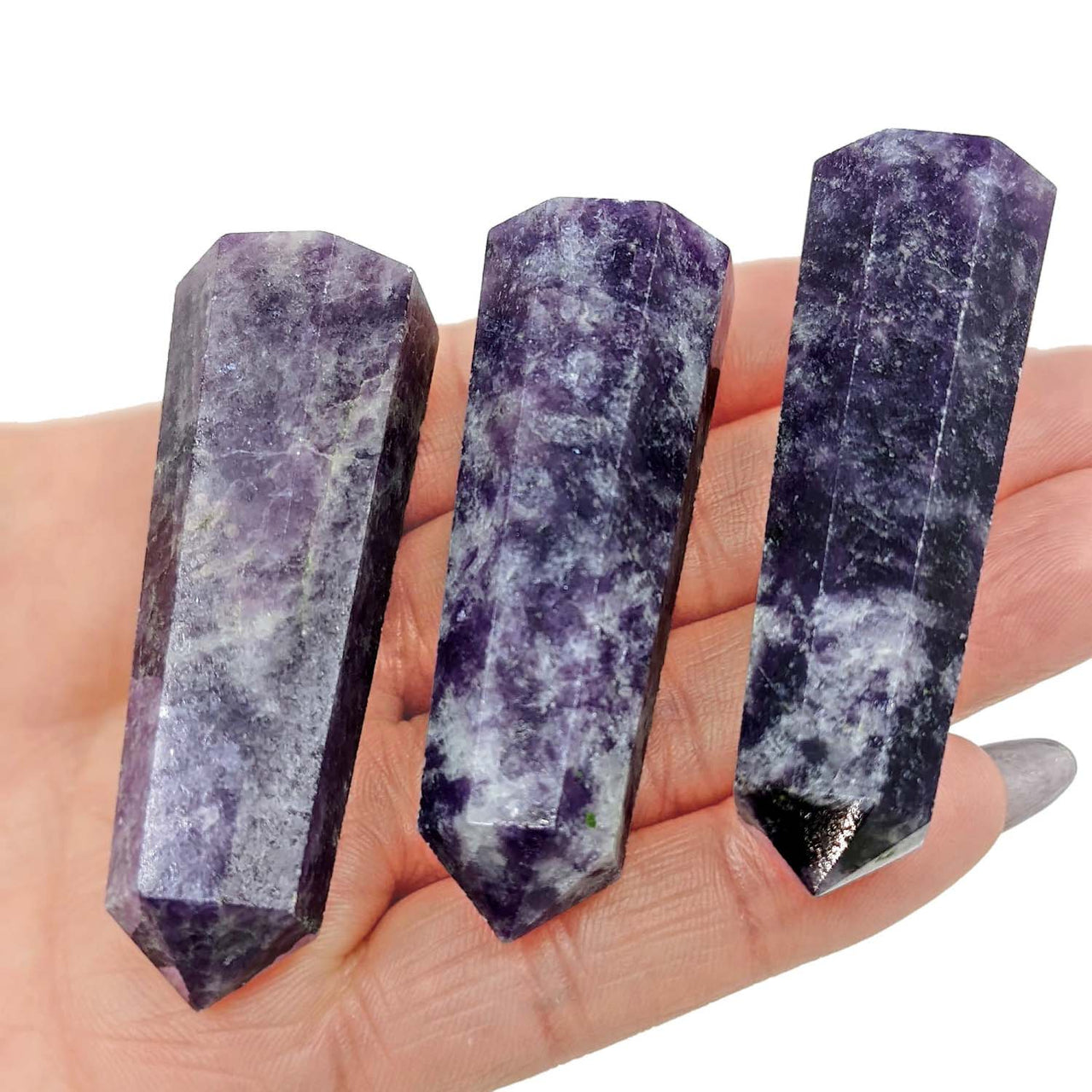 Three purple Amethyst crystal points showcasing natural striations on Lepidolite DT Wand