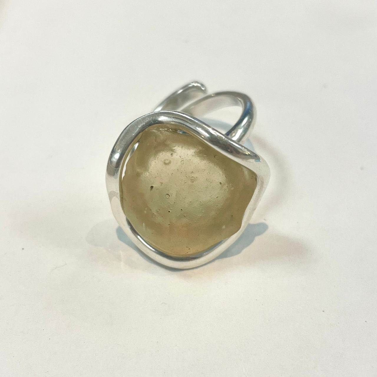 Silver ring with polished amber Libyan Desert Glass stone in an organic setting