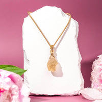 Gold raw citrine necklace with textured chain and rose-gold accents
