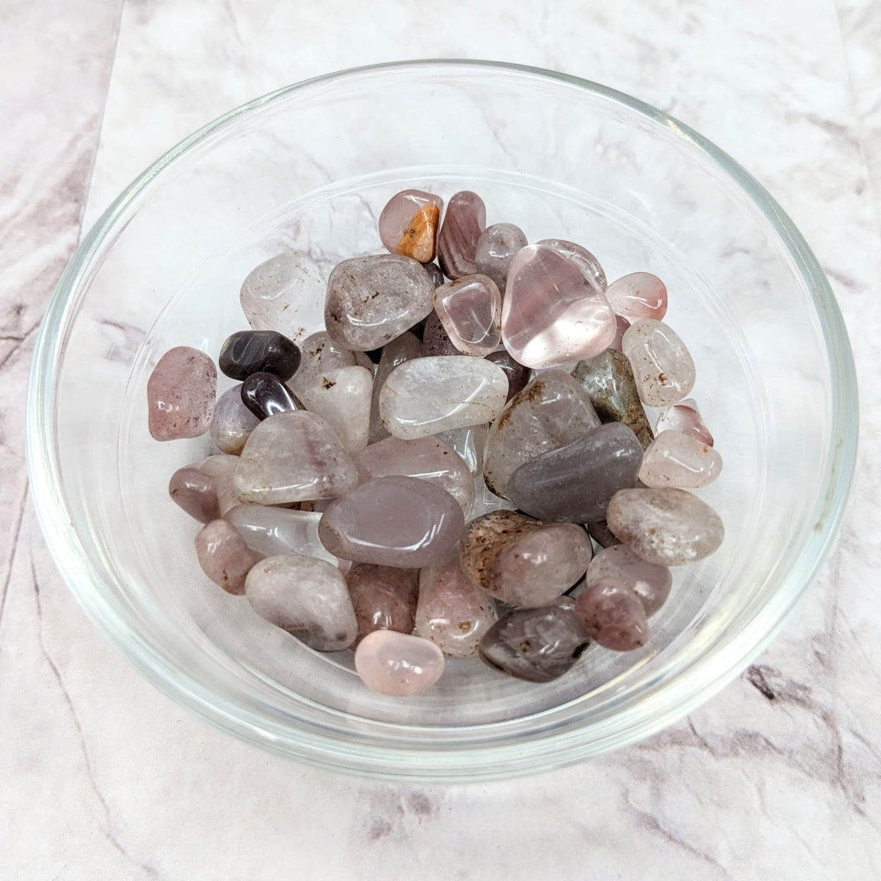 A bowl filled with lithium quartz tumbled stones from ’Lithium Quartz Small Tumble 5 Stone Parcel’