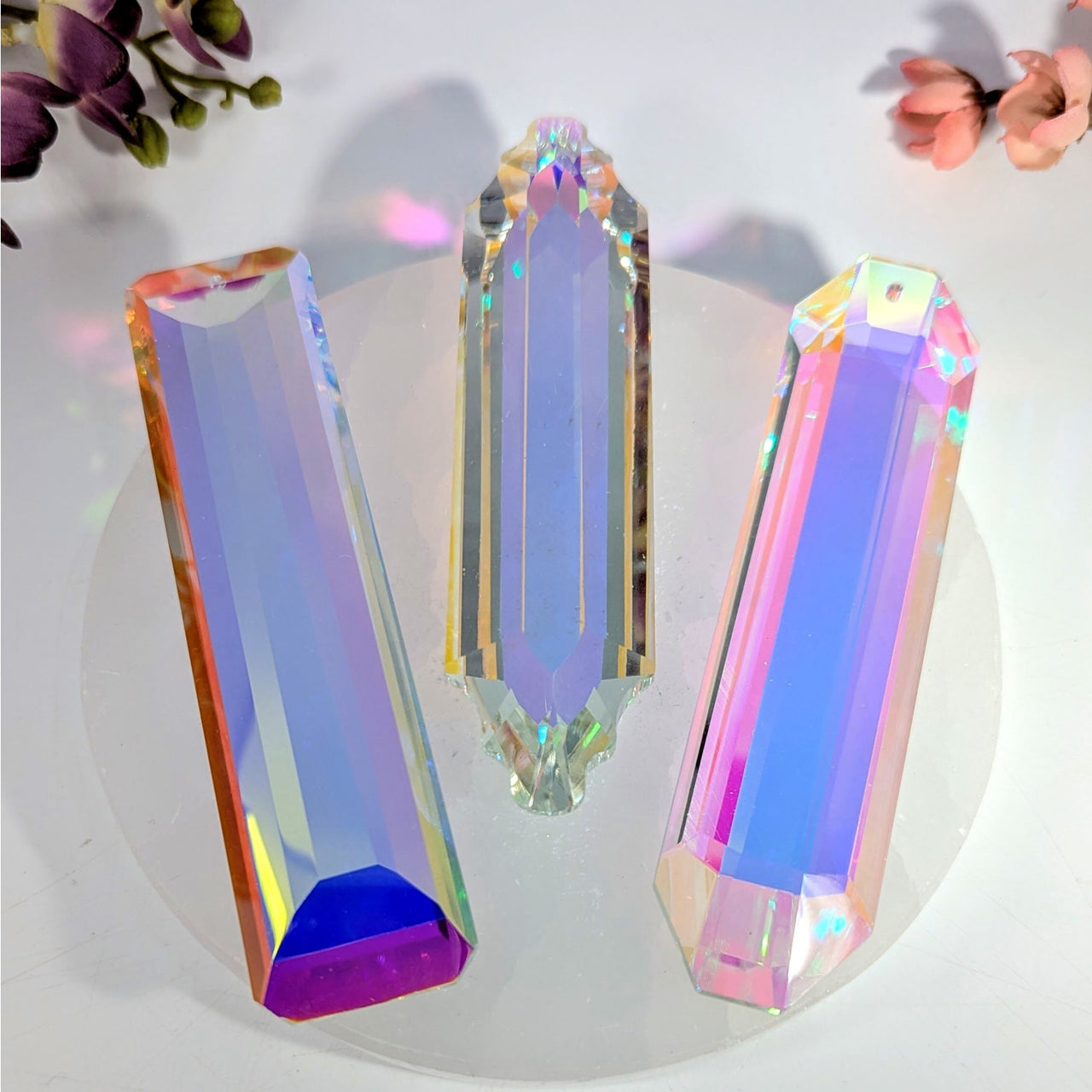 Three iridescent 4.75’’ prism rainbow catcher pendants in purple, blue, pink, orange, green hues