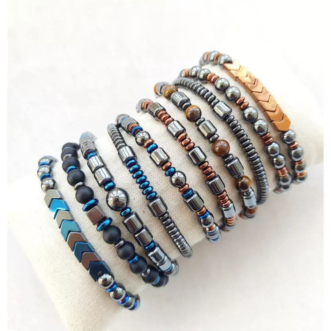 Assorted beaded stretch bracelets featuring Hematite, Onyx, and Tiger’s Eye gemstones