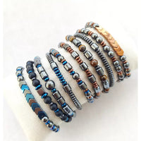 Assorted beaded stretch bracelets featuring Hematite, Onyx, and Tiger’s Eye gemstones