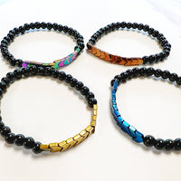 Four beaded men’s hematite gemstone bracelets with colorful metal accents