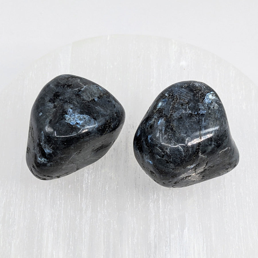 Two black obsidian quartz hearts against a white background - Merlinite Indigo Gabbro Pebble