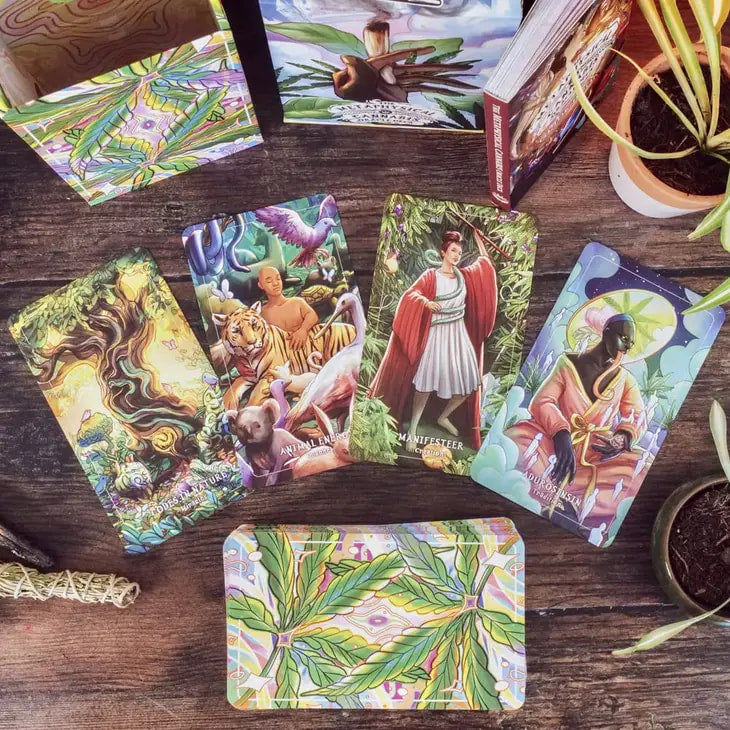 A table with a bunch of cards and plants from Metaphysical Cannabis Oracle Deck #Q167