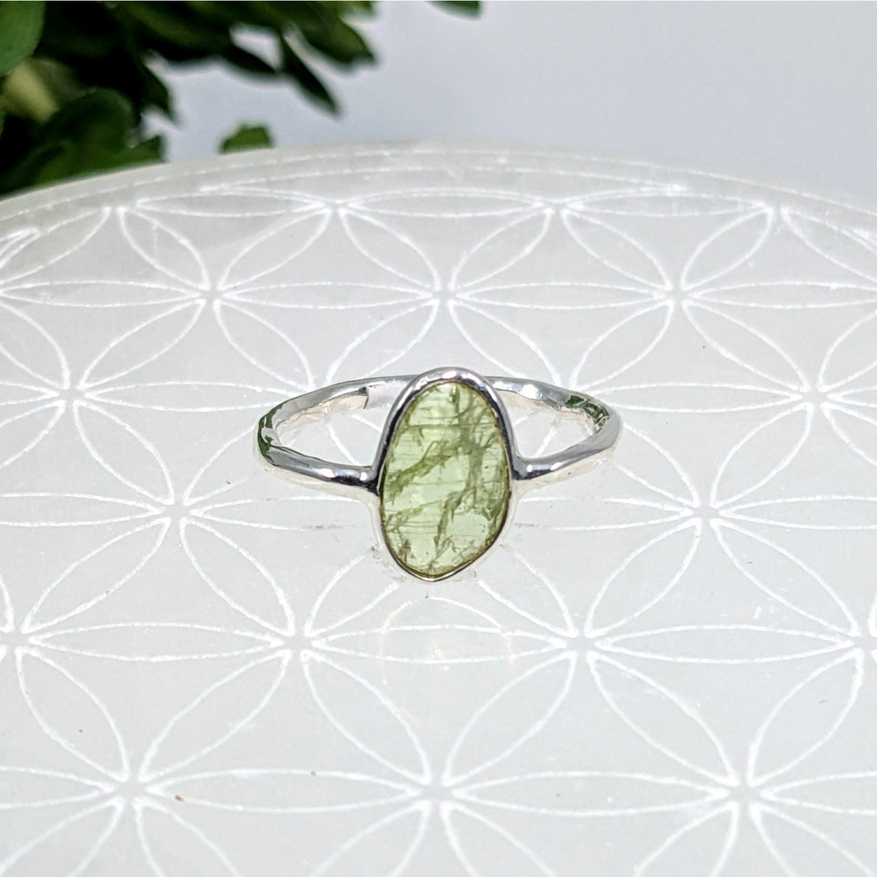 Delicate silver ring showcasing an oval green Kyanite stone in size 6