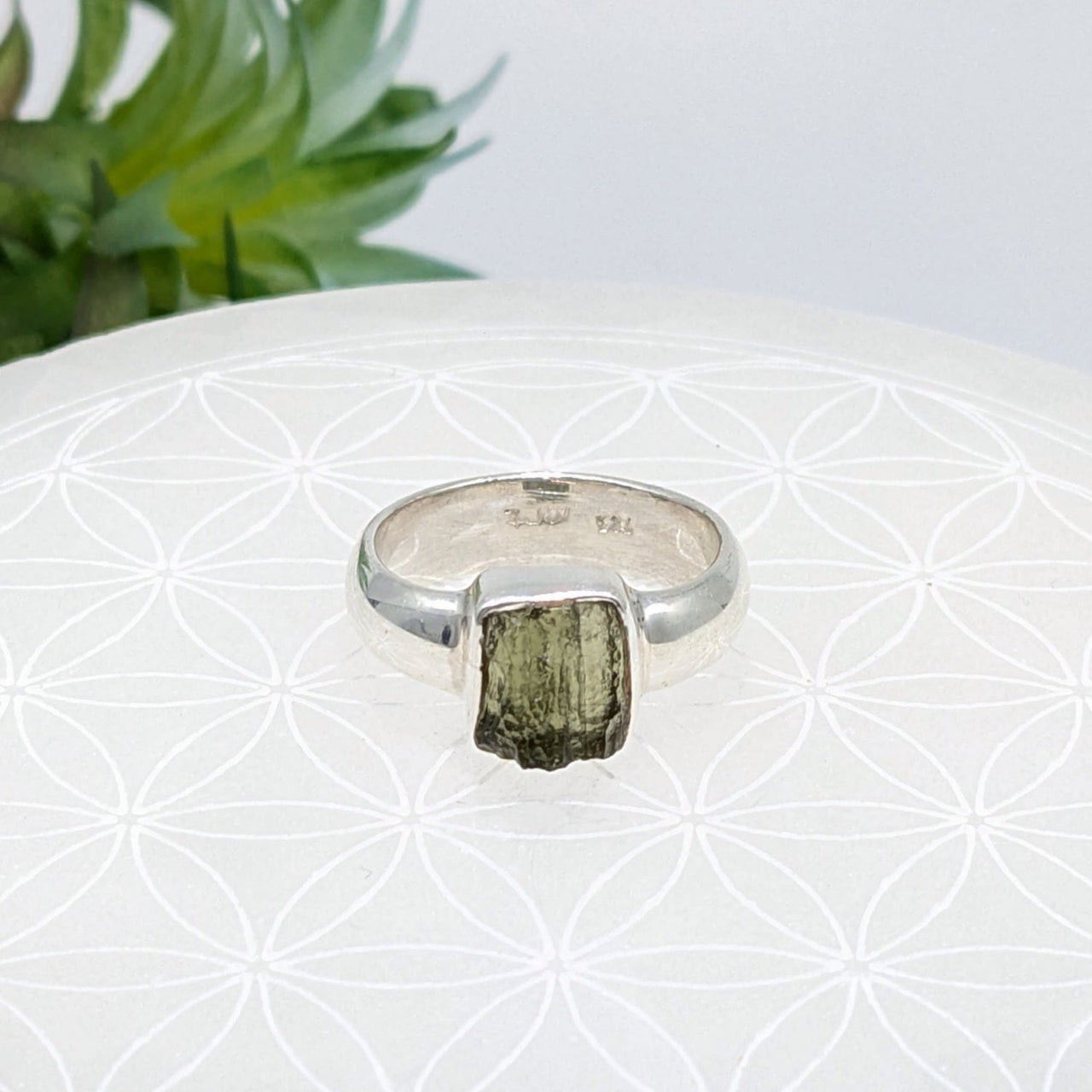 Silver ring with raw green tourmaline crystal, showcasing Moldavite energy and crystals