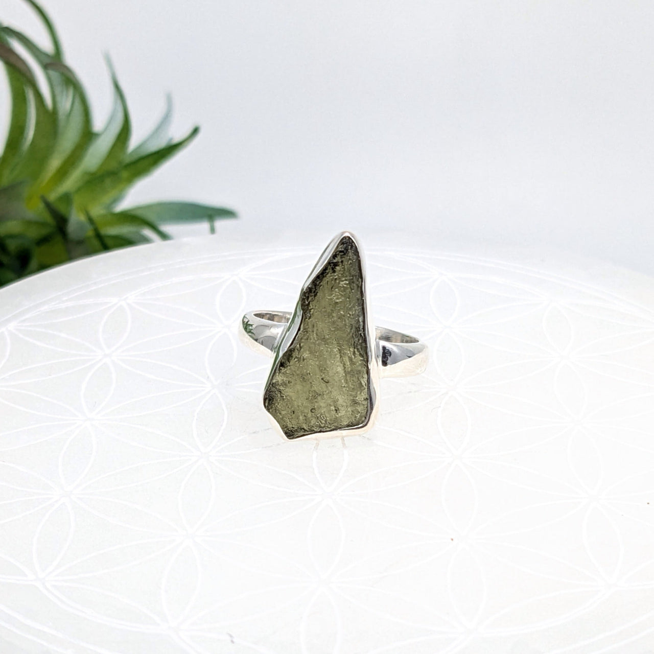 Raw Moldavite crystal set in a silver ring, enhancing energy with natural crystals