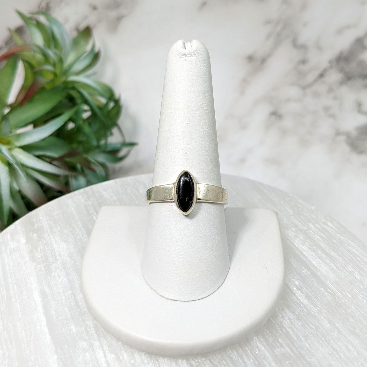 Black diamond ring on a white marble pedestal - Moldavite Sz 10 Polished Oval Ring #LV5114