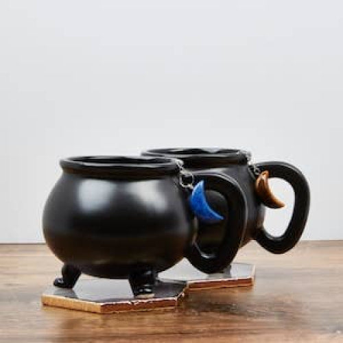 Black mug with blue handle on table, featuring Moon Crystal Tea Infuser #LV5490