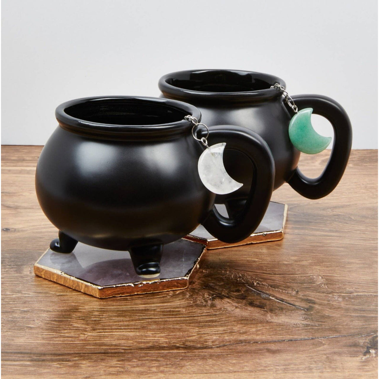 Two black pots on a wooden table with Moon Crystal Tea Infuser - Tea Strainer #LV5490