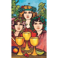 Three golden chalices on a wooden surface with Morgan-Greer Tarot in a Tin LV4404