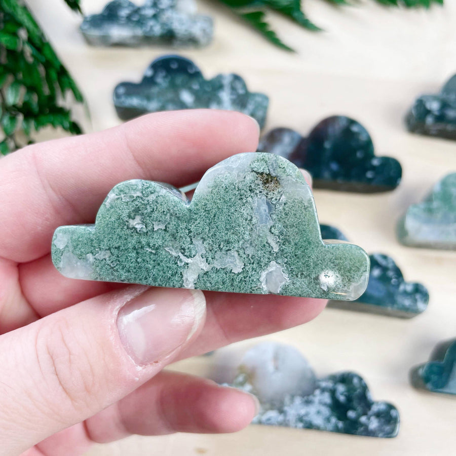 Hand holding polished moss agate cloud carving #LV9099 with green white swirls