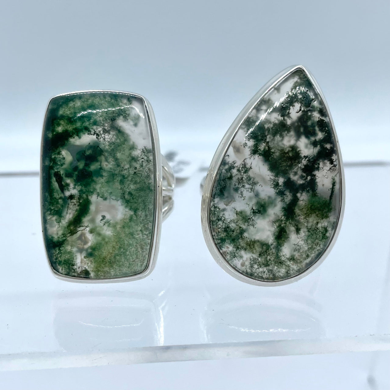 Two sterling silver moss agate rings showcasing unique green and white patterns