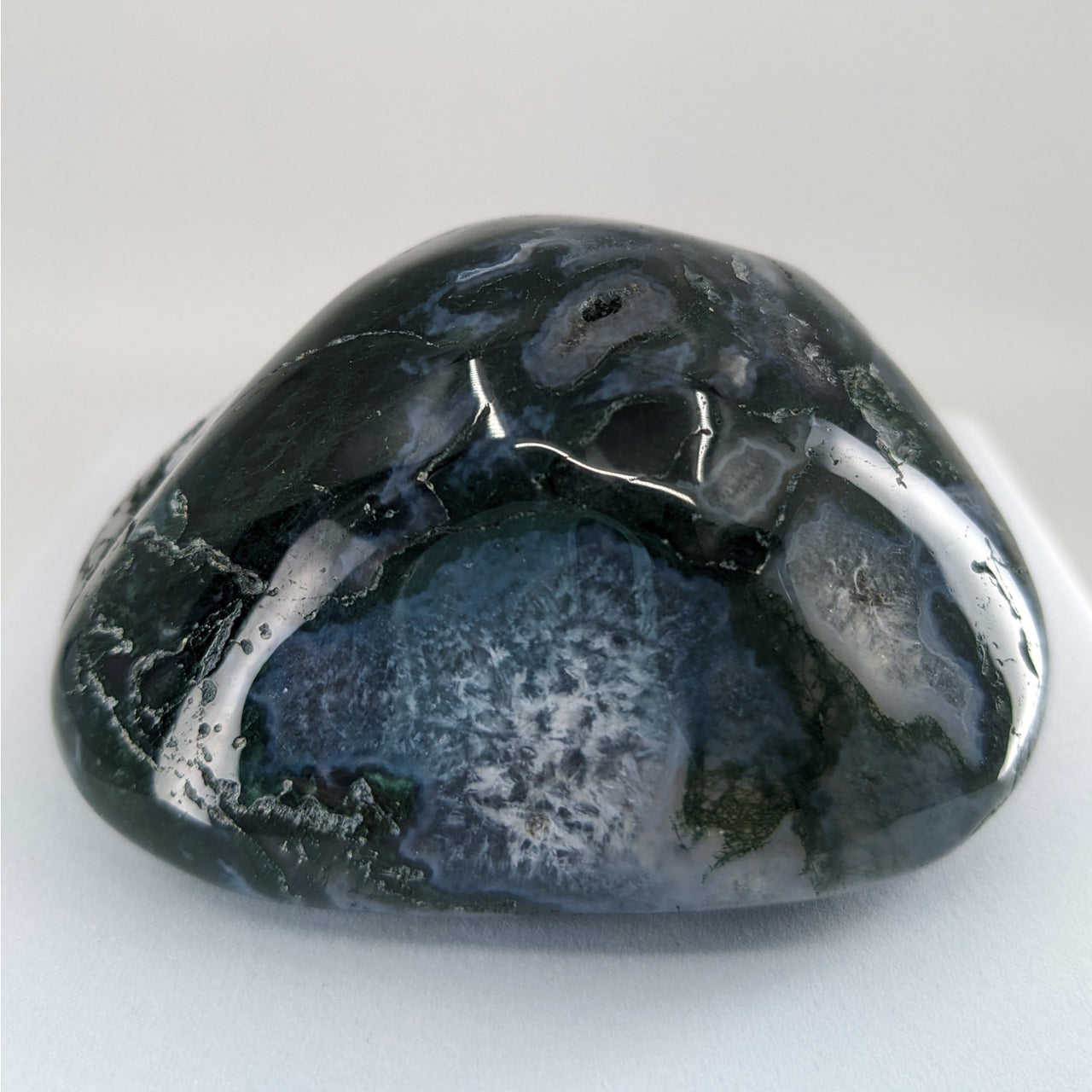 Moss Agate Touchstones #P165 featuring a large black and white stone against a white background