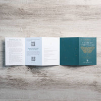 Teal folded booklet titled the moth a game of storytelling with gold-embossed butterfly design inspired by gemstones crystals