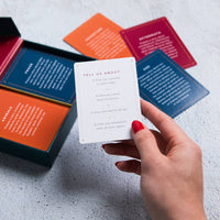 White card from The Moth Presents storytelling game with gold foil text and dotted border featuring reflective prompts
