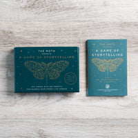 Teal rectangular storytelling game box by The Moth with gold foil moth illustration suitable for jewelry and crystals fans