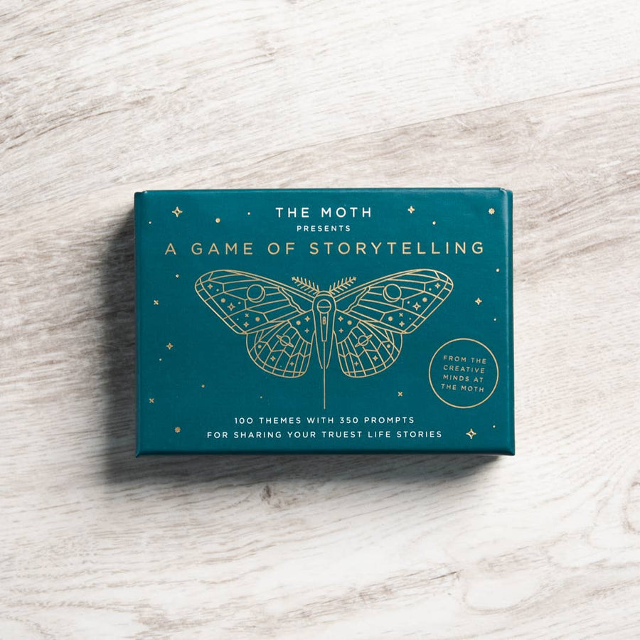 Teal rectangular storytelling game box with gold embossed moth design from the moth featuring jewelry gemstone themes