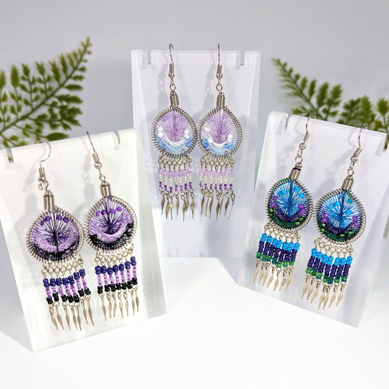 Multi color 2.5 inch web style earrings with purple and blue beads metallic wire frame and dangling gemstone strands jewelry
