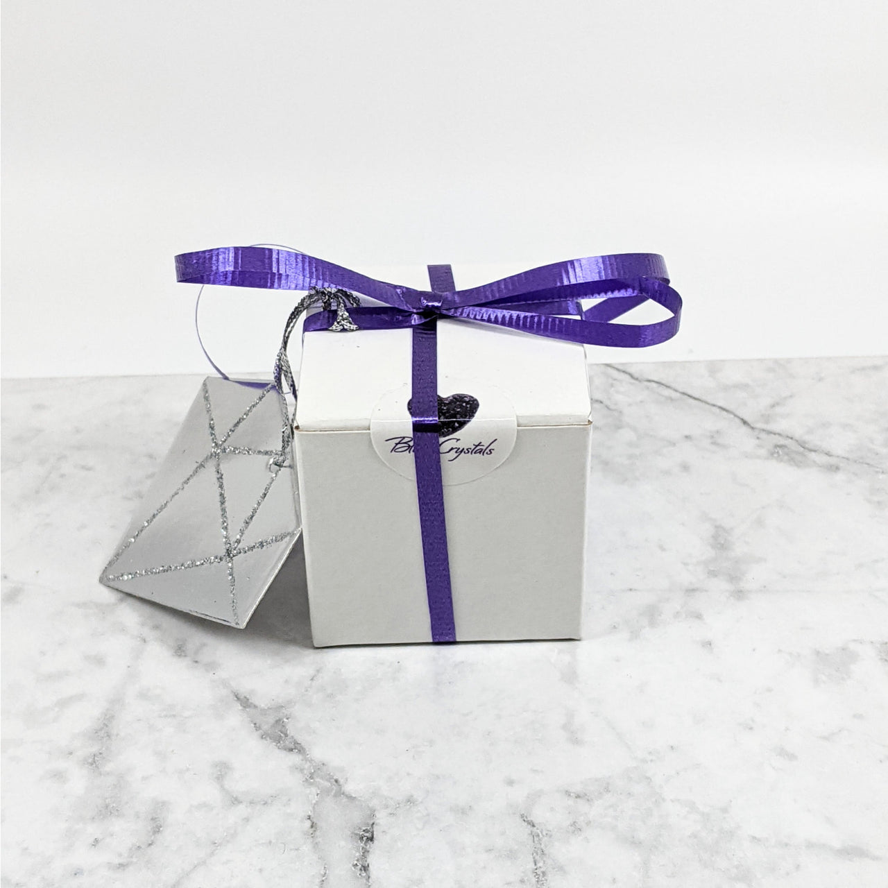 Silver gift box with purple ribbon for Mystery Boxes Galentines Edition #K205