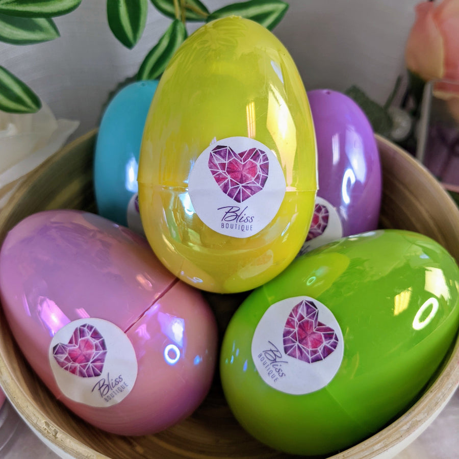 Colorful egg-shaped containers with Heart logo for Mystery Treasure Egg Bliss Crystals Gift