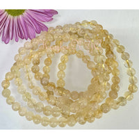 Strands of yellow Citrine gemstone beads on a Natural Citrine crystal stretch bracelet