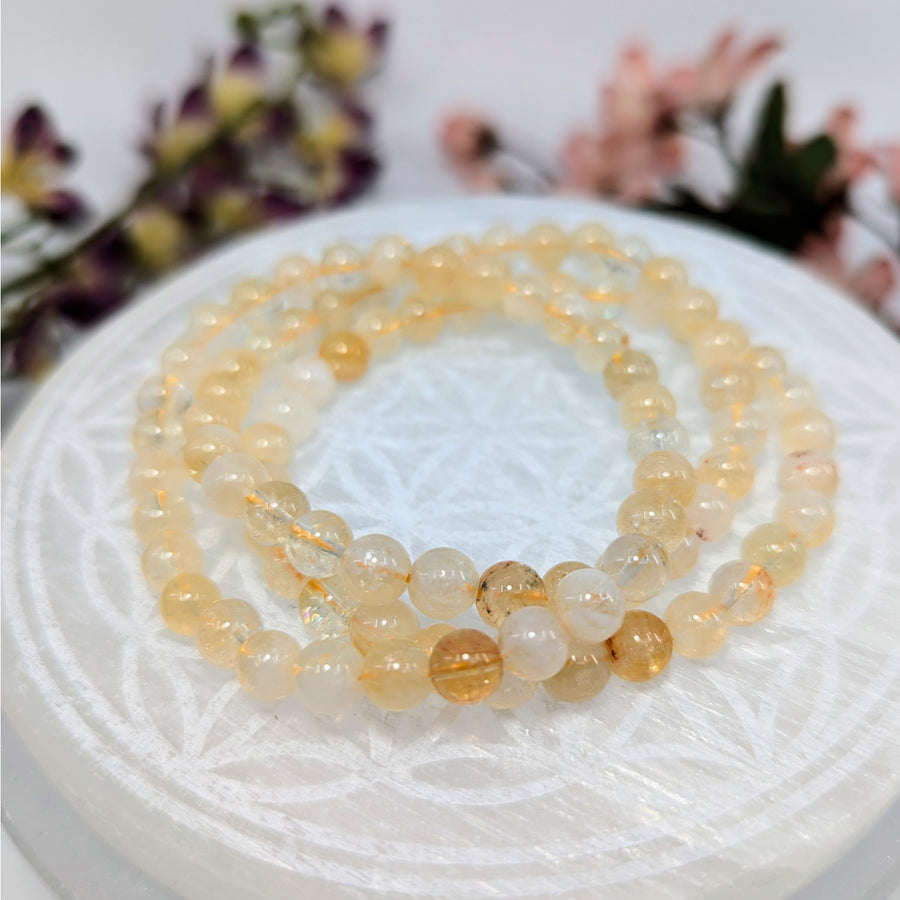 Natural Citrine 6mm crystal stretch bracelets featuring three golden bead bracelets