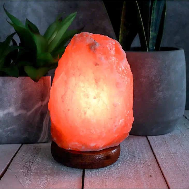 Natural PINK Himalayan Salt Lamp 3-5 lbs #LV3571 on a table emits a calming amber glow