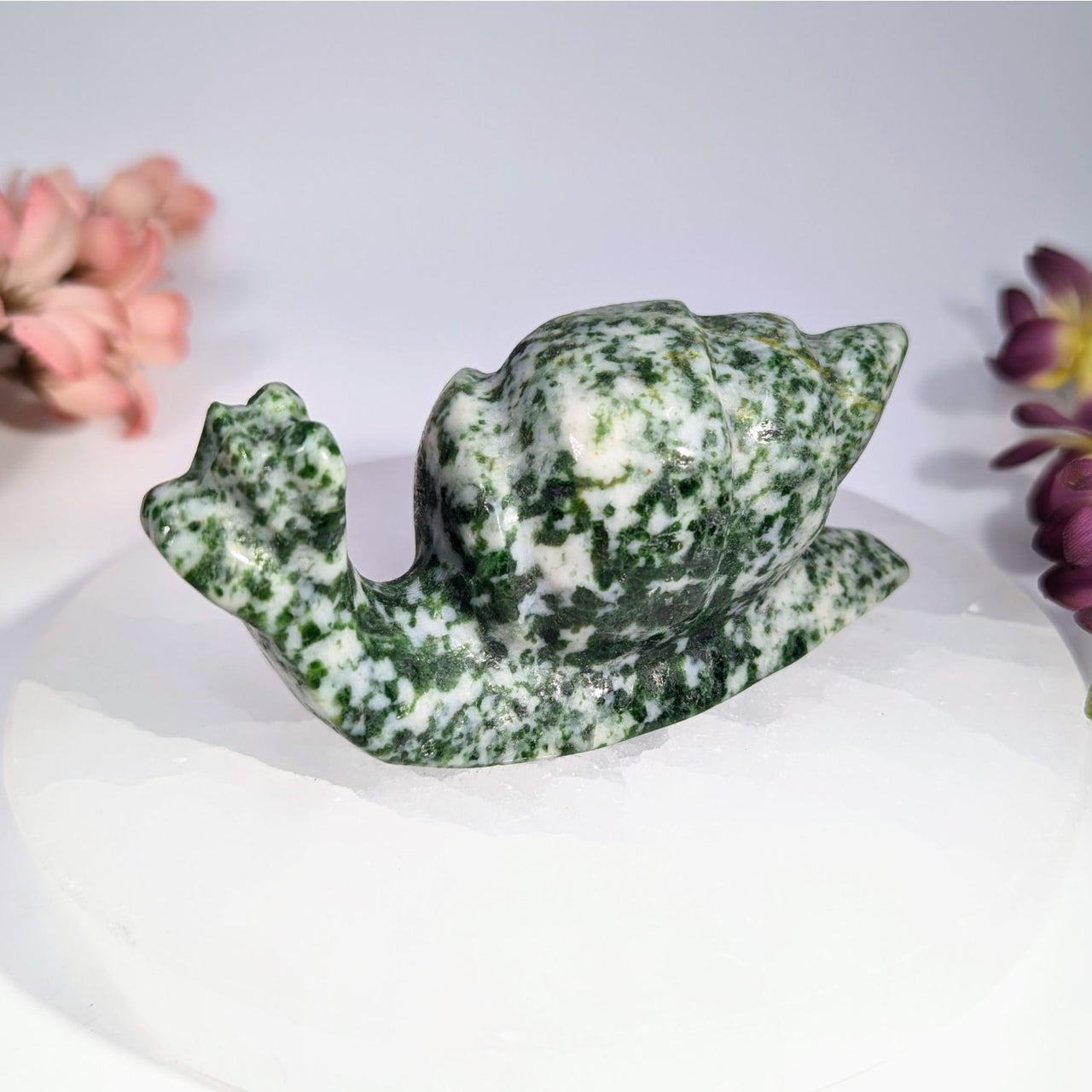 Polished green and white speckled nephrite jade snail carving, 3.8 inches