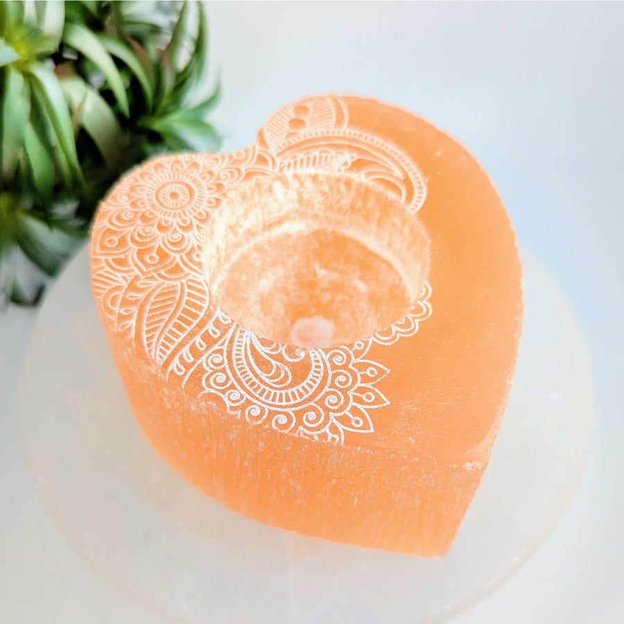 Engraved heart-shaped Orange Selenite candle holder for ambient lighting and decor