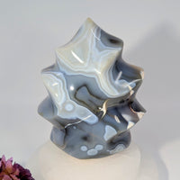 Polished translucent Orca Agate 5-inch flame freeform sculpture with gray white swirls