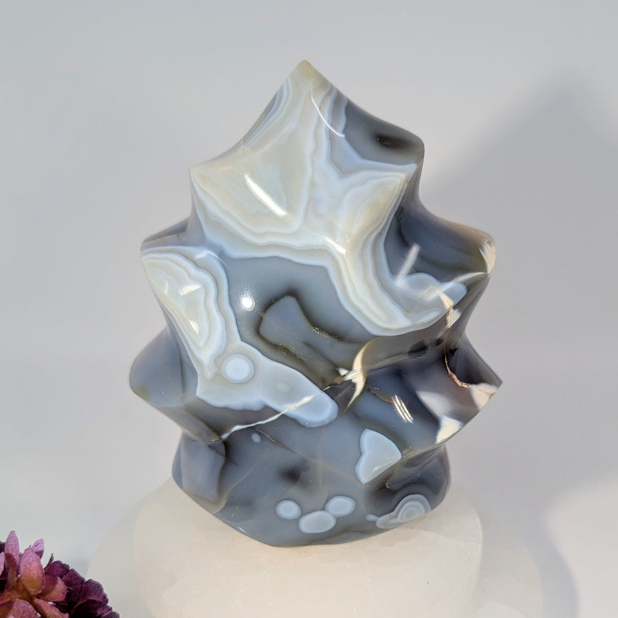 Polished translucent Orca Agate 5-inch flame freeform sculpture with gray white swirls